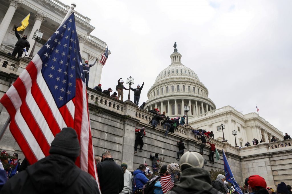 FILE PHOTO: Supporters of U.S. President Donald Trump climb on walls at the U.S. Capitol during a protest against the certification of the 2020 U.S. presidential election results by the U.S. Congress, in Washington, U.S., January 6, 2021. REUTERS/Jim Urquhart