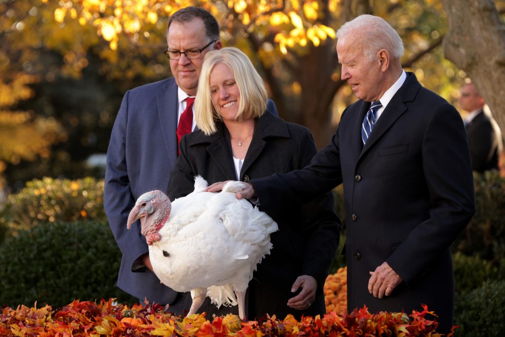 WASHINGTON, DC – NOVEMBER 19: Accompanied by Chairman of National Turkey Federation Phil Seger (L) and turkey grower Andrea Welp (C), U.S. President Joe Biden participates in the 74th annual Thanksgiving turkey pardon of Peanut Butter in the Rose Garden of the White House November 19, 2021 in Washington, DC. The 2021 National Thanksgiving Turkey, Peanut Butter, and alternate, Jelly, were raised in Jasper, Indiana and will reside on the campus of Purdue University in West Lafayette, Indiana, after today’s presentation. (Alex Wong/Getty Images)