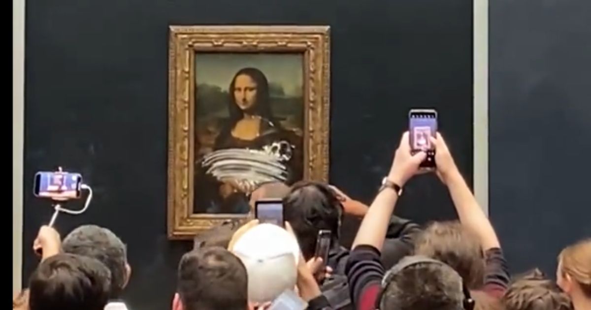 ‘Old Woman’ in a Wheelchair Gets Close to ‘Mona Lisa,’ Guards Scramble as Man in Disguise Launches Attack
