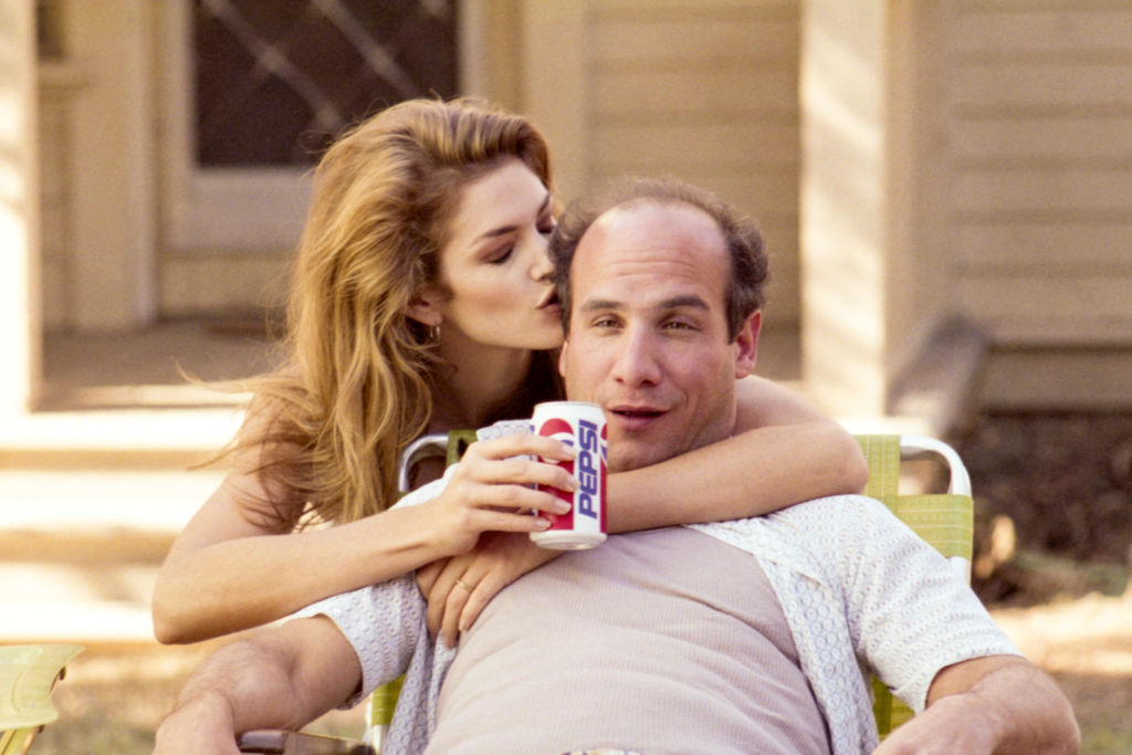 Actress and model Cindy Crawford holds a Pepsi can while appearing as the dream of actor Paul Ben-Victor on the set of a Pepsi commercial in 1993 in Los Angeles, California. (Photo by Roxanne McCann/Getty Images.)