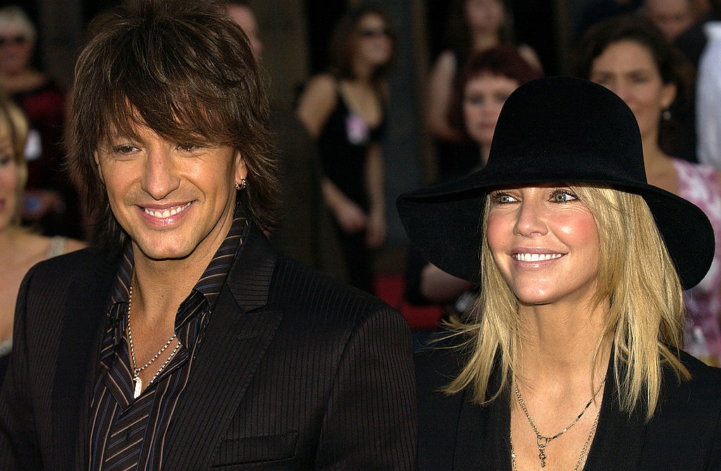 LOS ANGELES – NOVEMBER 14: Actress Heather Locklear (right) and her husband Richie Sambora arrive at the 32nd Annual “American Music Awards” on November 14, 2004 at the Shrine Auditorium, in Los Angeles, California. (Photo by Vince Bucci/Getty Images)